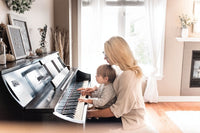 Mother and child playing piano